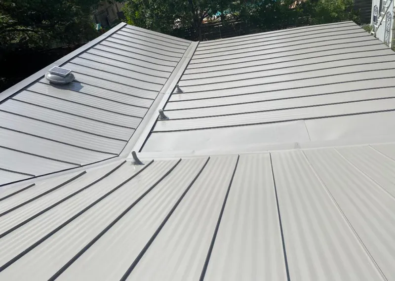 Solar attic fan installed on a metal roof for Roof Ventilation in Sand Lake